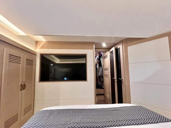  Yacht Photos Pics 2025 Beneteau Swift Trawler 54 bedroom interior with modern design and ample storage.