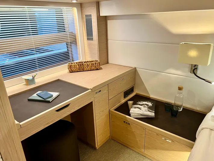  Yacht Photos Pics Interior cabin of 2025 Beneteau Swift Trawler 54 with desk and storage.