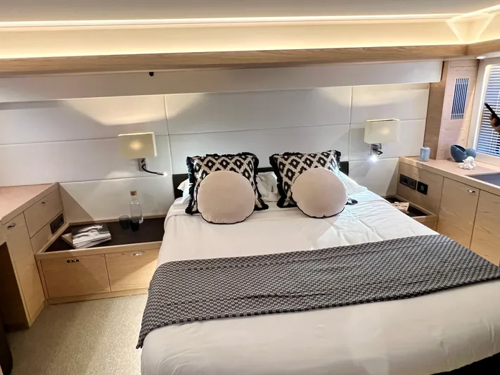  Yacht Photos Pics Luxurious bedroom in 2025 Beneteau Swift Trawler 54 yacht with modern decor.