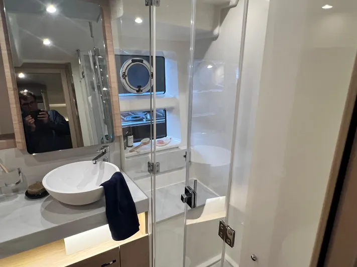  Yacht Photos Pics Modern bathroom on 2025 Beneteau Swift Trawler 54 with glass shower and vessel sink.