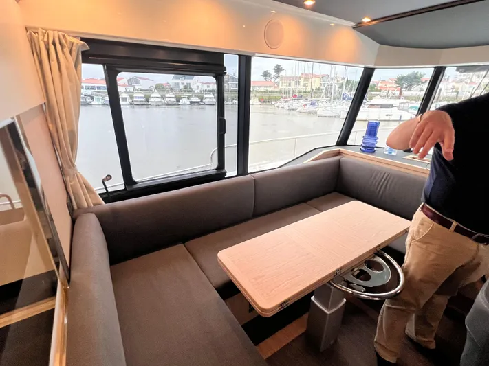  Yacht Photos Pics Interior seating area of 2025 Beneteau Swift Trawler 54 with waterfront view.