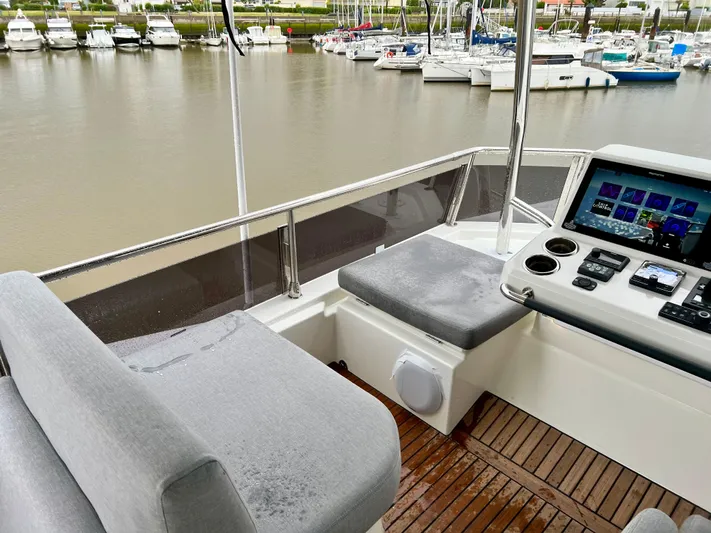  Yacht Photos Pics Flybridge of 2025 Beneteau Swift Trawler 54 with seating and navigation controls.