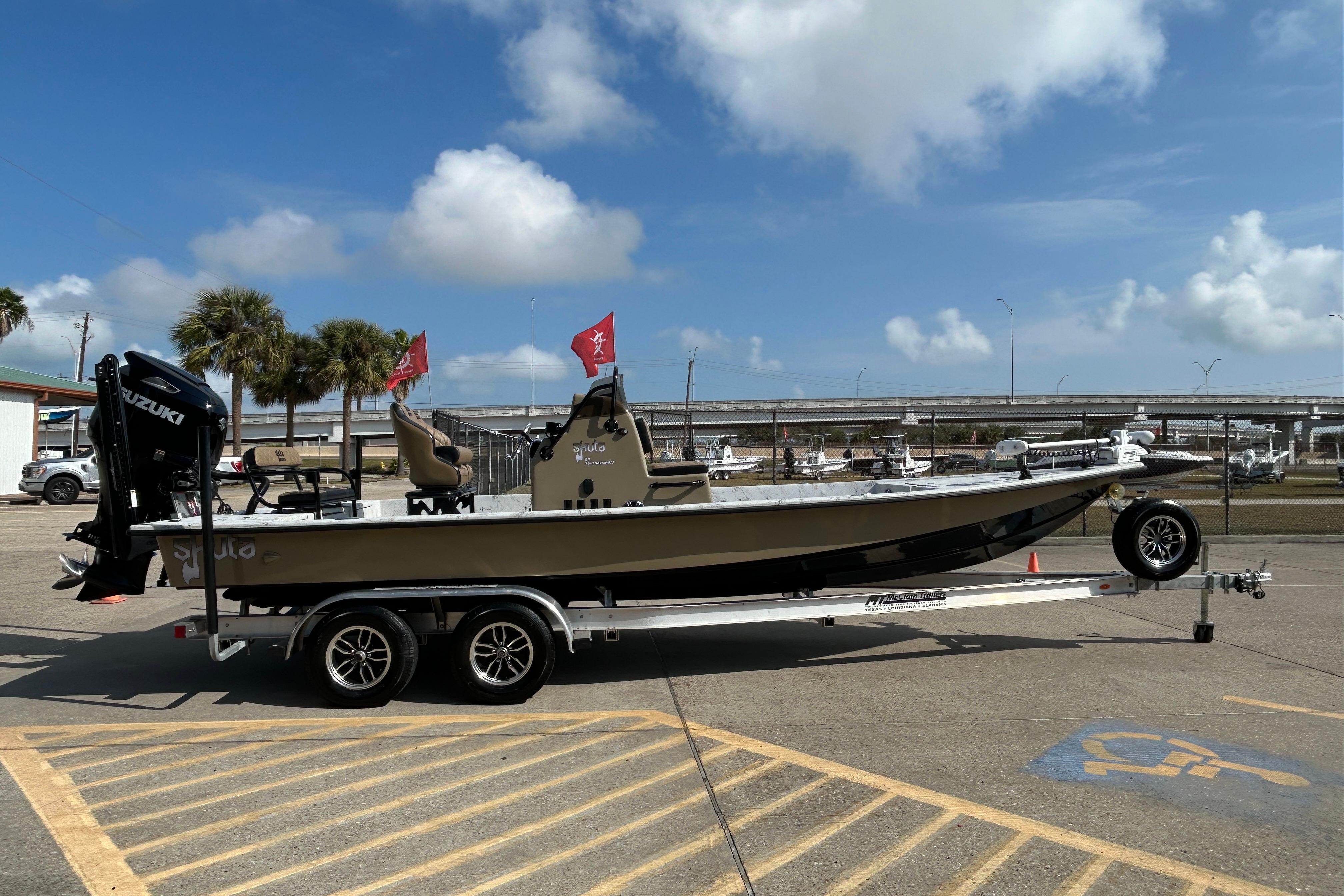 2026 Skuta 24 Vista boat on trailer, parked outdoors under a clear blue sky.