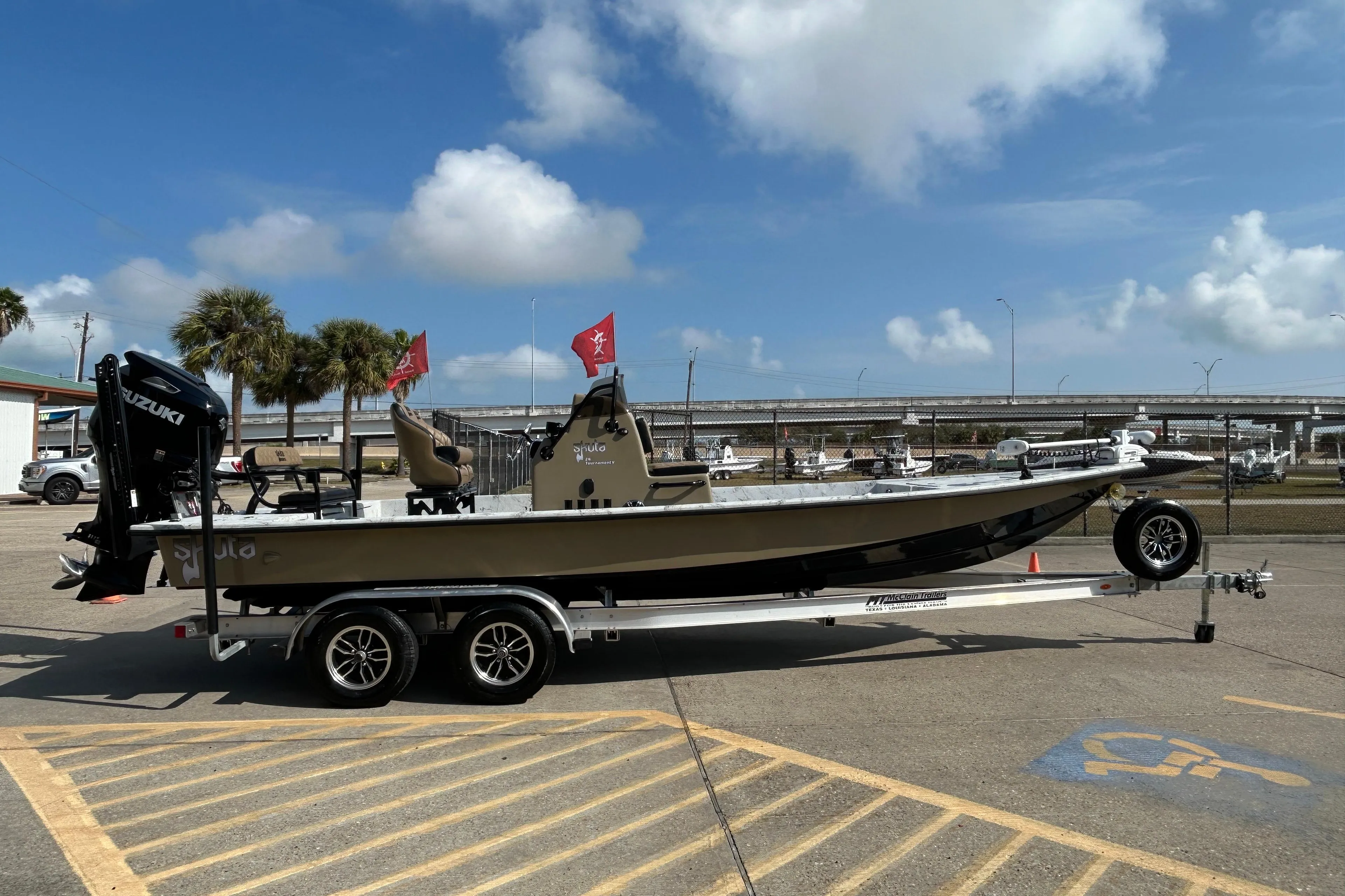2026 Skuta 24 Vista boat on trailer, parked outdoors under a clear blue sky.