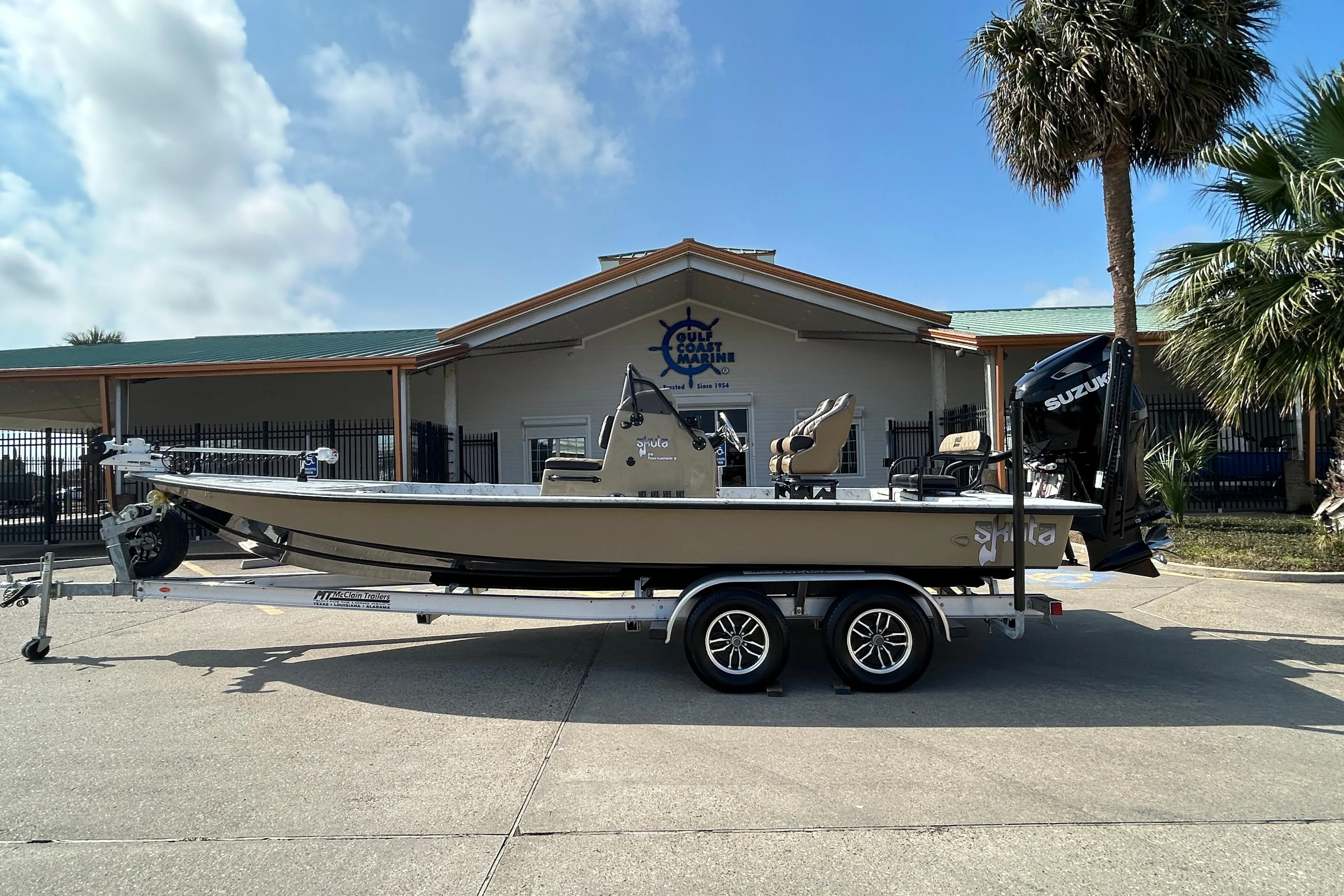 2026 Skuta 24 Vista boat on trailer outside Gulf Coast Marine dealership.