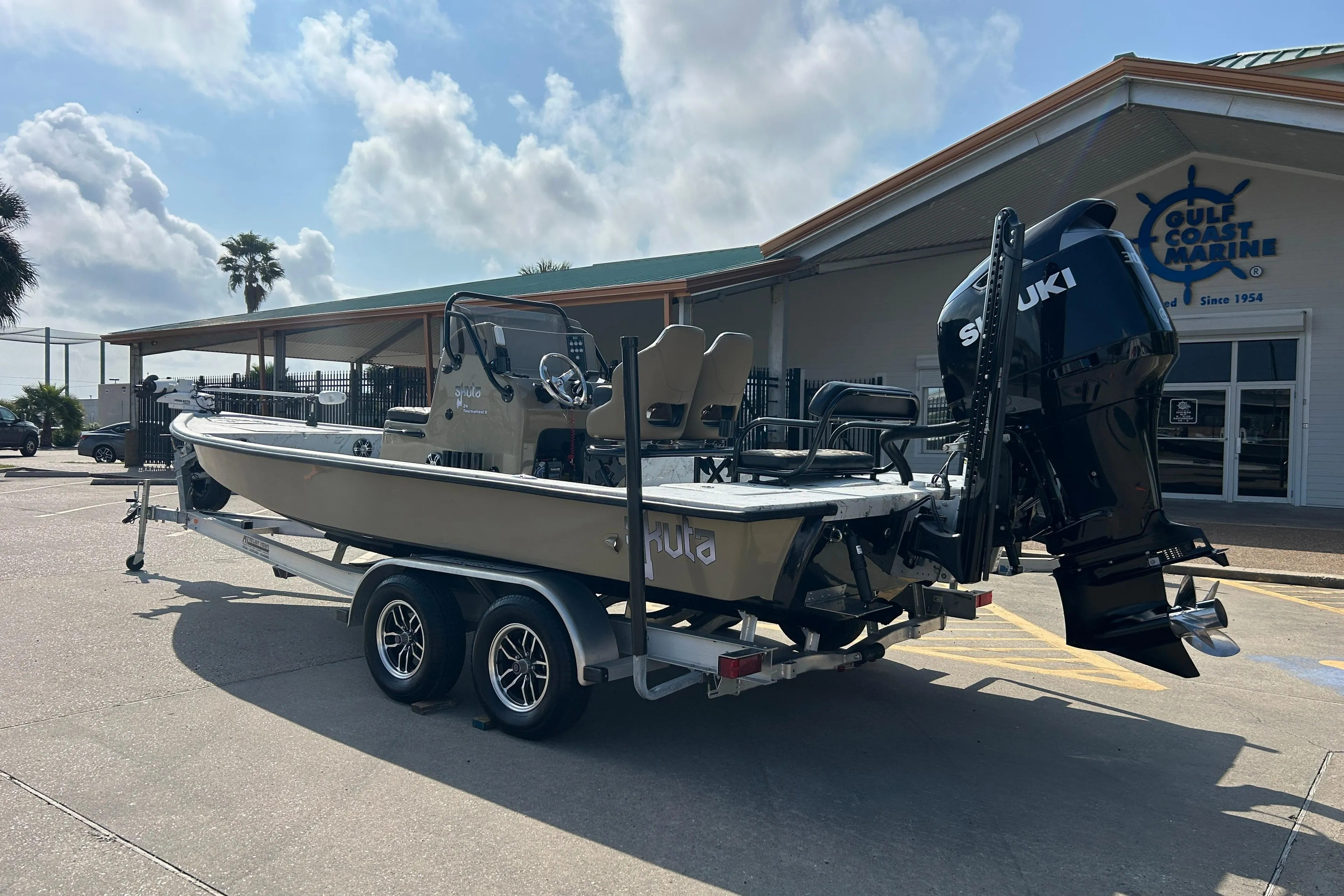 2026 Skuta 24 Vista boat on trailer outside Gulf Coast Marine dealership.