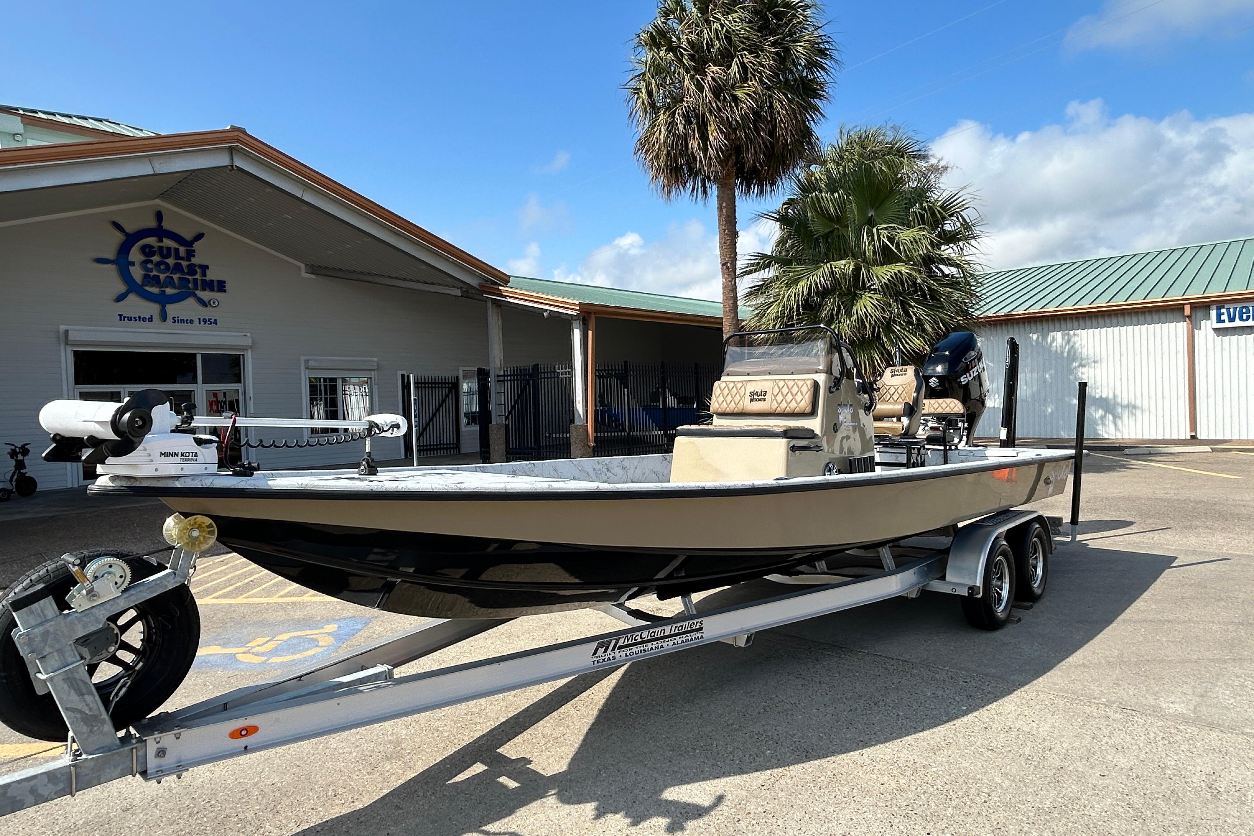 2026 Skuta 24 Vista boat on trailer at Gulf Coast Marine dealership.