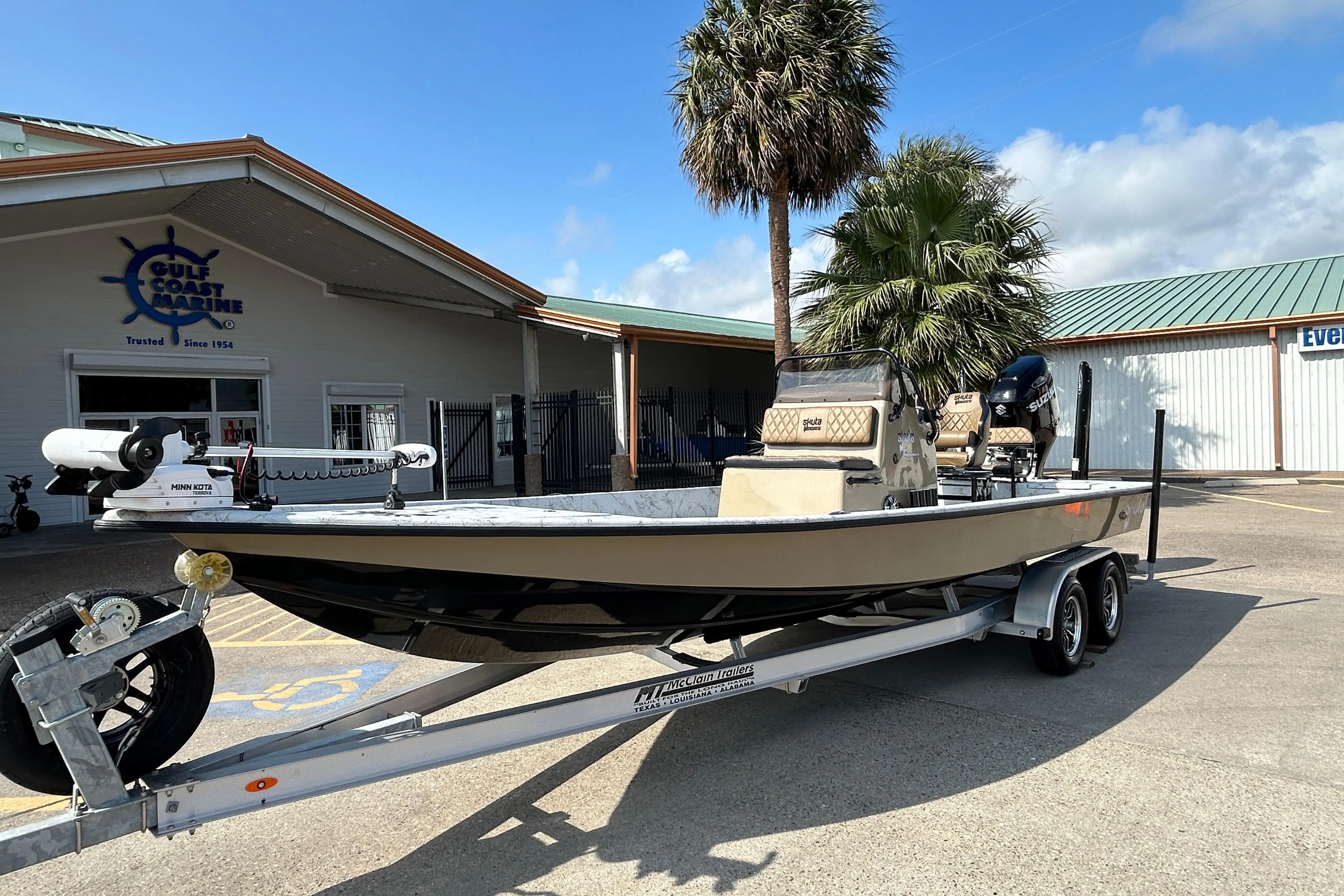 2026 Skuta 24 Vista boat on trailer at Gulf Coast Marine dealership.