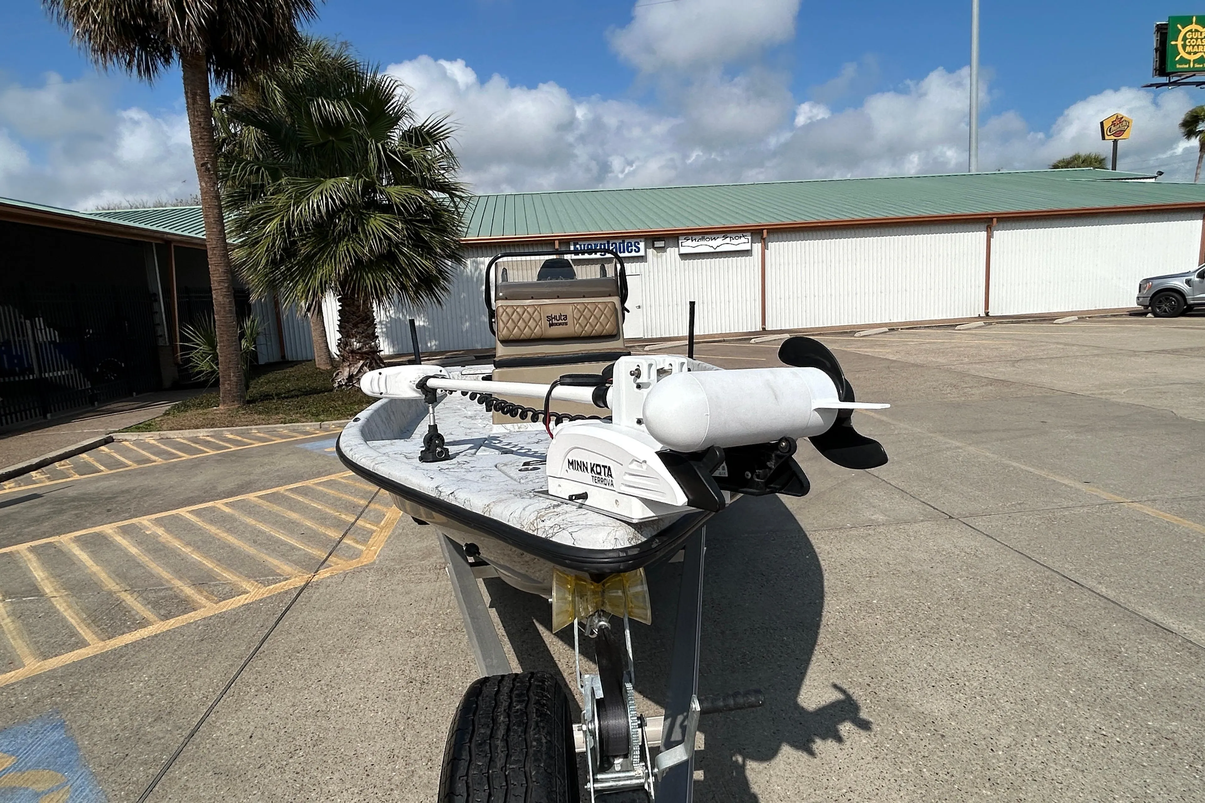 2026 Skuta 24 Vista boat on trailer in sunny parking lot.