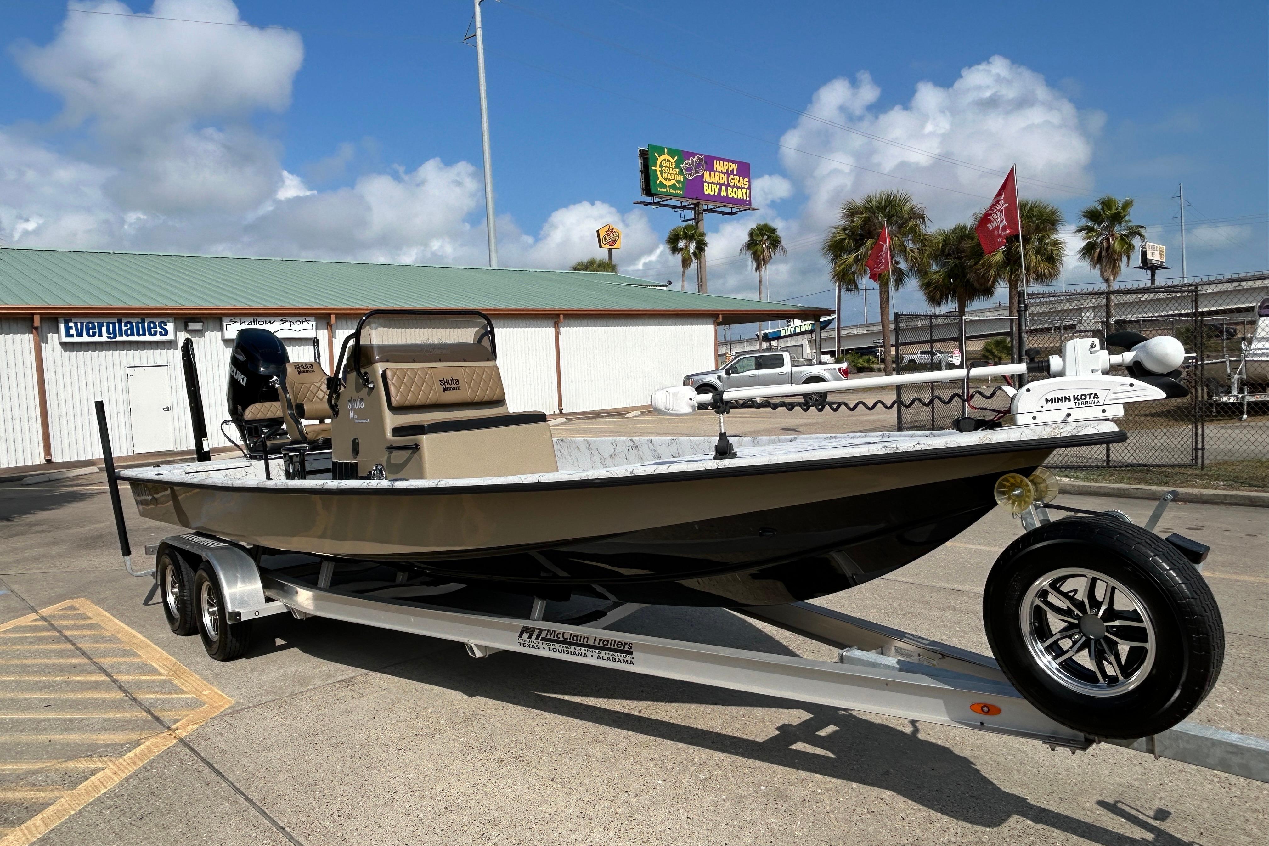 2026 Skuta 24 Vista boat on trailer, parked outdoors under a clear sky.