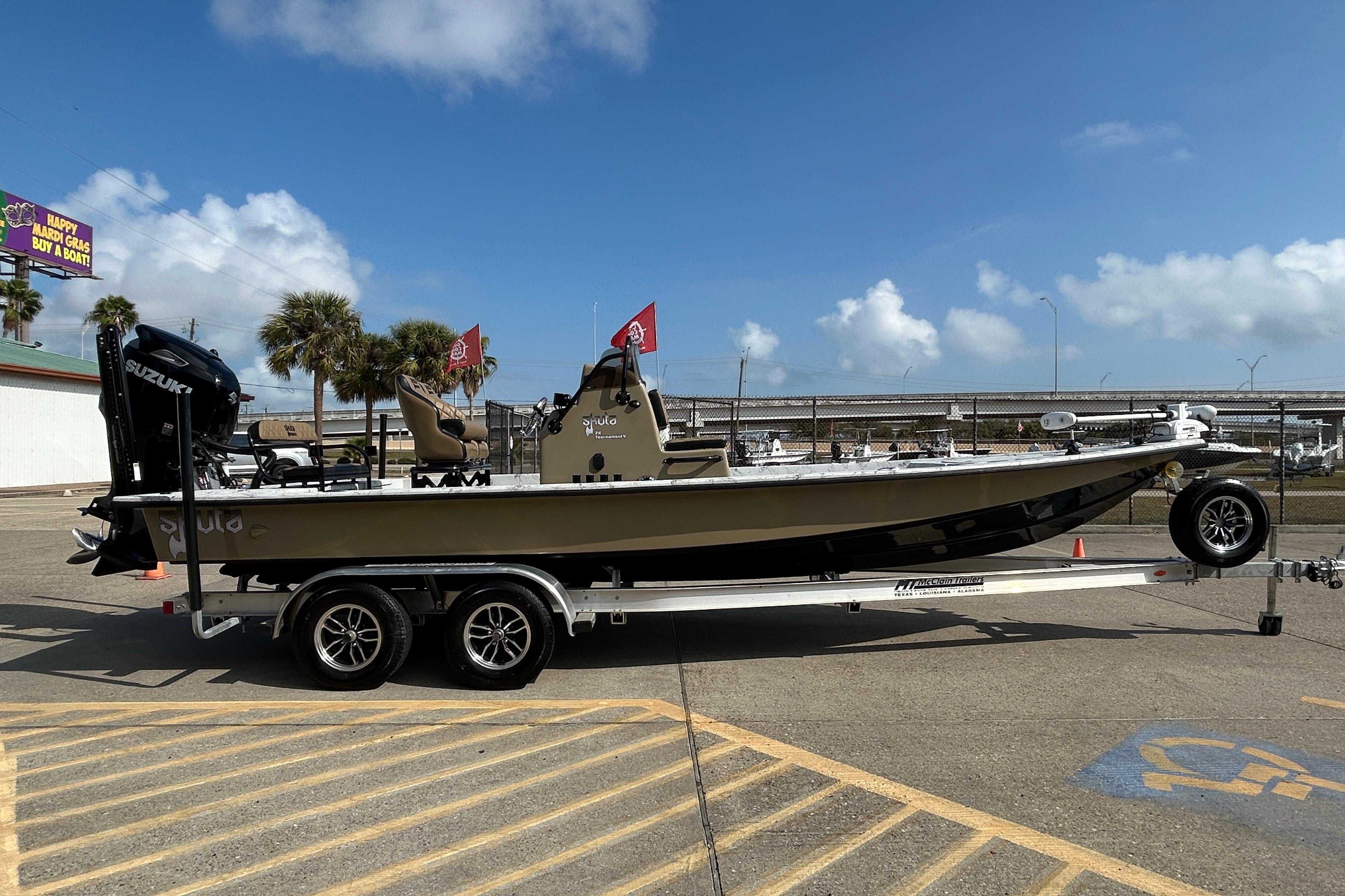2026 Skuta 24 Vista boat on trailer, parked outdoors under a clear sky.