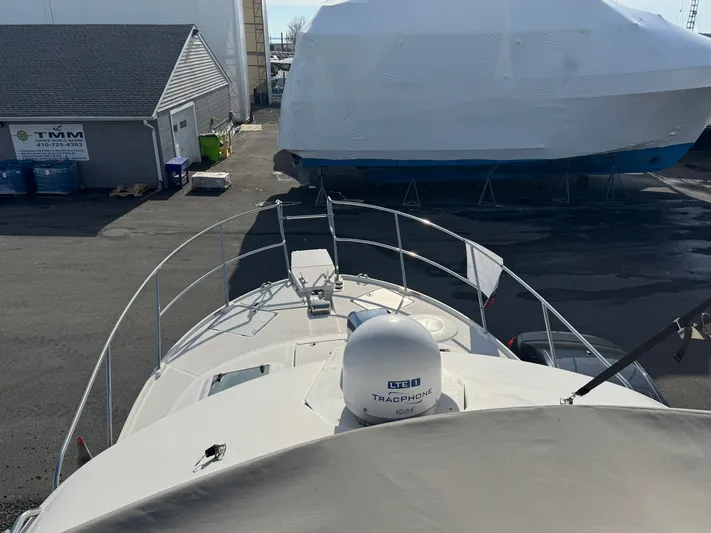  Yacht Photos Pics 2021 Cutwater C-32 CB boat docked, view from the deck, with covered vessel nearby.