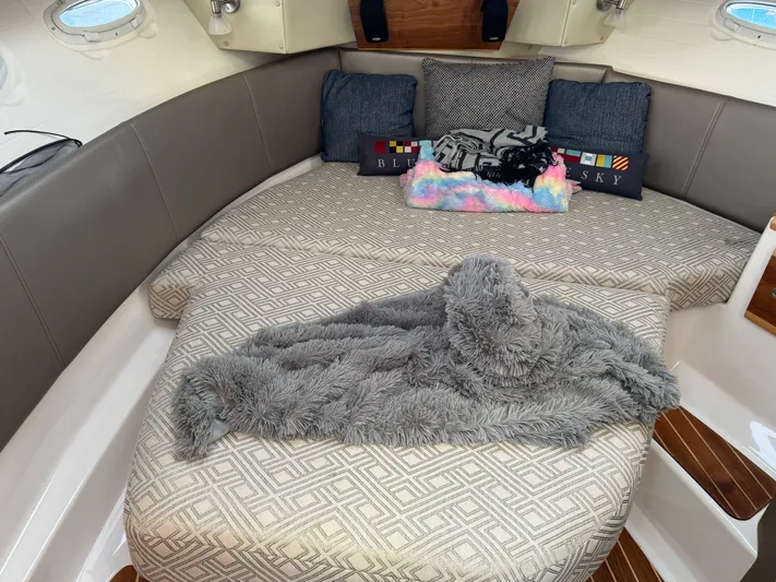  Yacht Photos Pics Cozy cabin interior of 2021 Cutwater C-32 CB with plush bedding and cushions.