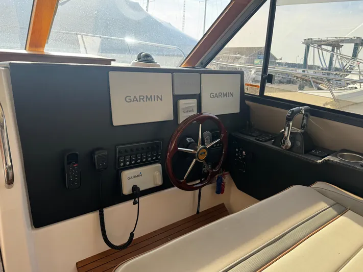  Yacht Photos Pics 2021 Cutwater C-32 CB helm with Garmin navigation system and steering wheel.