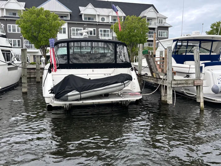  Yacht Photos Pics 1993 Sea Ray 500 Sundancer docked at marina with covered dinghy.