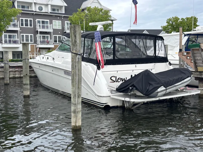  Yacht Photos Pics 1993 Sea Ray 500 Sundancer docked at marina with American flag.