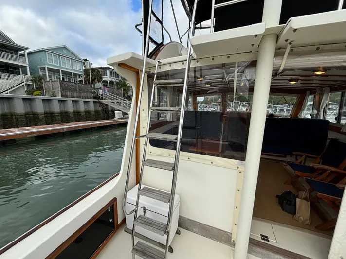 Gullywhumper Yacht Photos Pics 2001 Ellis 36 Flybridge boat with ladder, dockside view, and waterfront homes in the background.