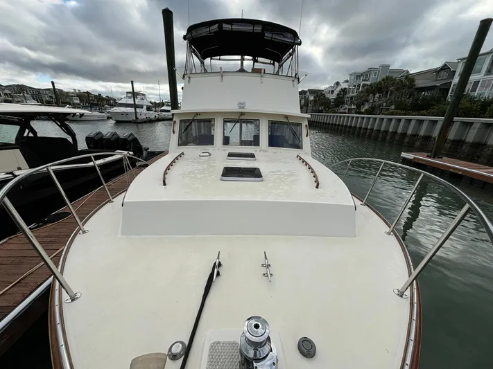 Gullywhumper Yacht Photos Pics 2001 Ellis 36 Flybridge boat docked in a marina under cloudy skies.