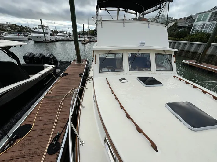 Gullywhumper Yacht Photos Pics Ellis 36 Flybridge 2001 docked at marina, overcast sky, adjacent boats visible.