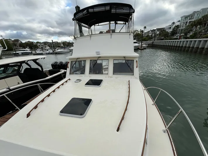 Gullywhumper Yacht Photos Pics 2001 Ellis 36 Flybridge boat docked in marina, overcast sky, waterfront homes in background.