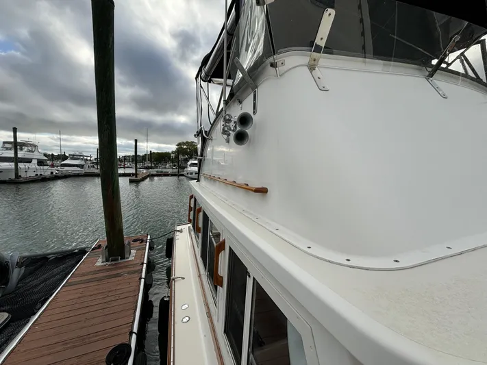 Gullywhumper Yacht Photos Pics 2001 Ellis 36 Flybridge yacht docked at marina under cloudy sky.