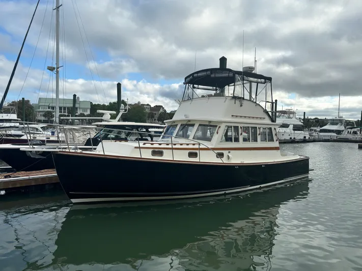 Gullywhumper Yacht Photos Pics Ellis 36 Flybridge 2001 yacht docked in marina under cloudy sky.