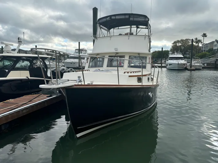 Gullywhumper Yacht Photos Pics 2001 Ellis 36 Flybridge boat docked in marina, overcast sky, surrounded by other vessels.