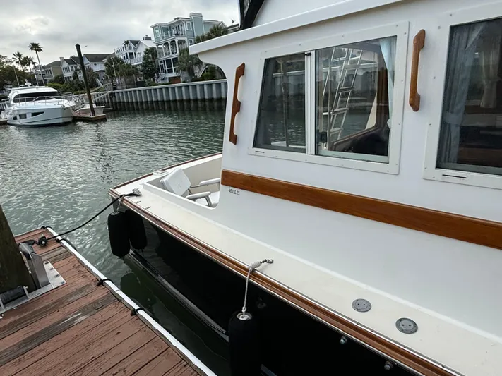 Gullywhumper Yacht Photos Pics 2001 Ellis 36 Flybridge yacht docked at marina, featuring classic design and wooden accents.