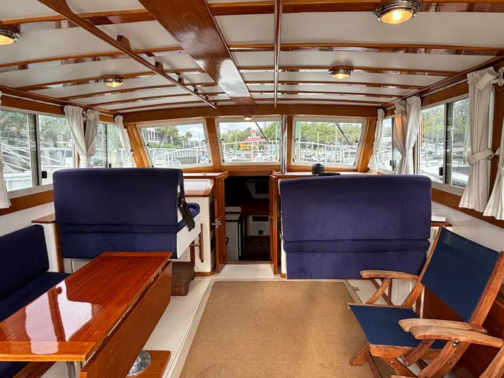 Gullywhumper Yacht Photos Pics Luxurious interior of 2001 Ellis 36 Flybridge yacht with wooden accents and plush seating.