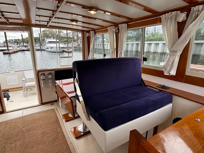 Gullywhumper Yacht Photos Pics Interior of 2001 Ellis 36 Flybridge yacht with blue seating and large windows.