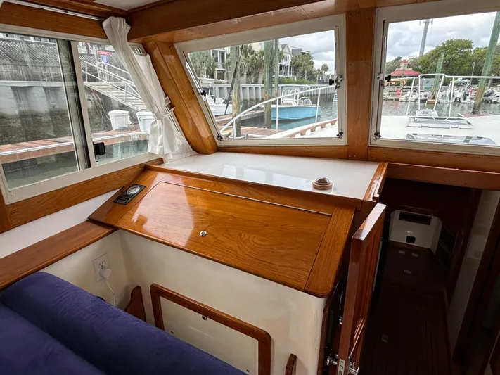 Gullywhumper Yacht Photos Pics Interior view of 2001 Ellis 36 Flybridge boat with wooden cabinetry and marina backdrop.