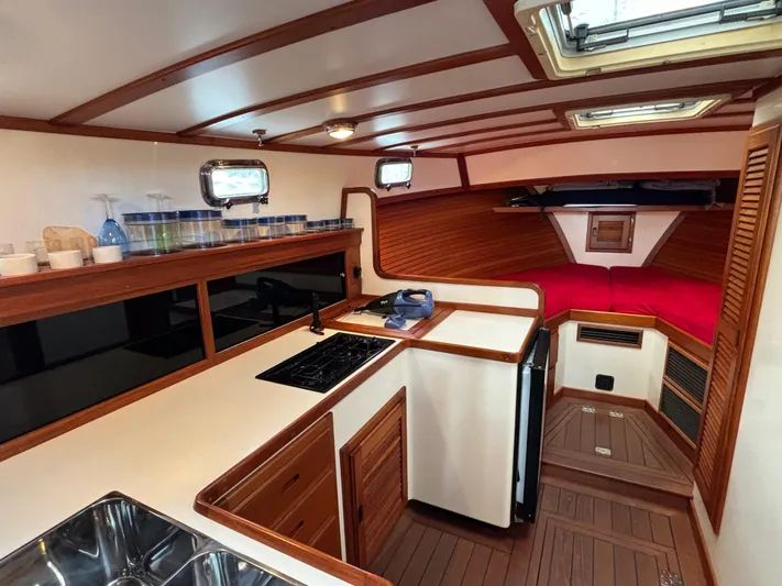 Gullywhumper Yacht Photos Pics Interior of 2001 Ellis 36 Flybridge yacht with kitchen and cozy sleeping area.