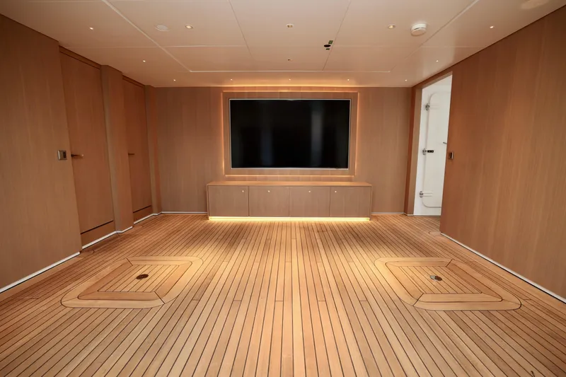  Yacht Photos Pics Luxurious interior of 2024 Rossinavi 49M Sport Yacht with wooden flooring and large TV.