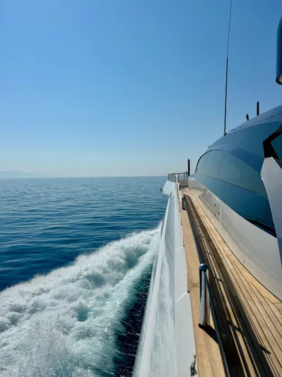  Yacht Photos Pics 2024 Rossinavi 49M Sport Yacht cruising on open sea under clear blue sky.