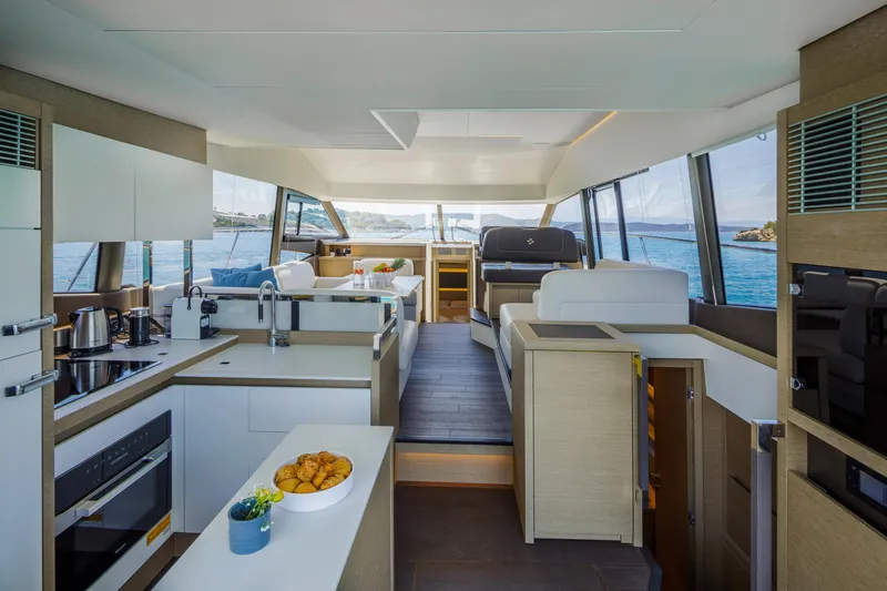  Yacht Photos Pics Luxurious interior of 2022 Prestige 520 yacht with modern kitchen and seating area.