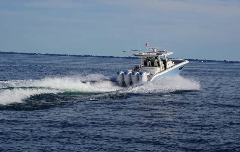  Yacht Photos Pics 2022 Pursuit 428 boat cruising on open water with powerful engines.