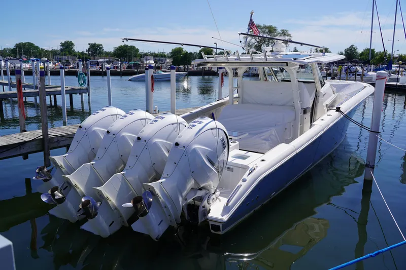  Yacht Photos Pics 2022 Pursuit 428 boat docked with four powerful outboard engines.