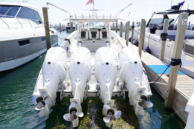  Yacht Photos Pics 2022 Pursuit 428 boat with four powerful outboard engines docked at marina.