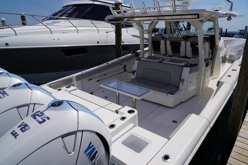  Yacht Photos Pics 2022 Pursuit 428 boat with Yamaha engines, docked, featuring spacious seating and modern design.