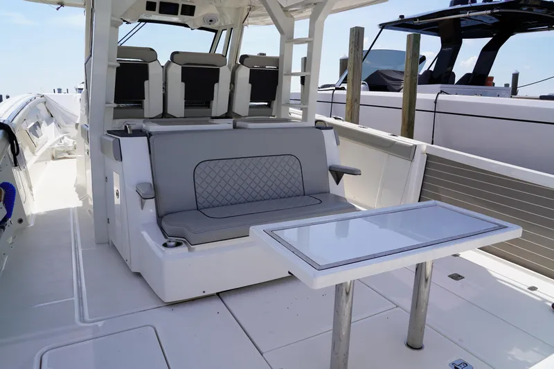  Yacht Photos Pics 2022 Pursuit 428 boat interior with seating and table, showcasing luxury design.