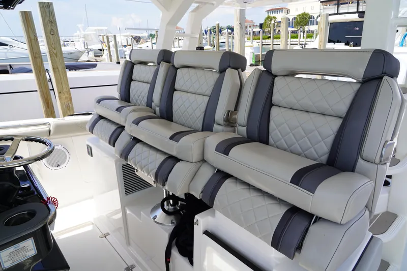  Yacht Photos Pics Luxurious seating on 2022 Pursuit 428 boat, featuring quilted upholstery and modern design.