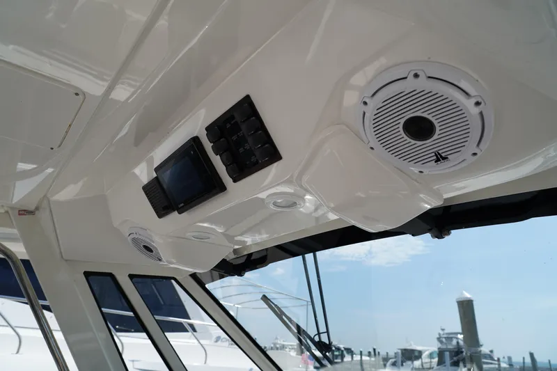  Yacht Photos Pics Interior view of a 2022 Pursuit 428 boat, featuring speakers and control panel.