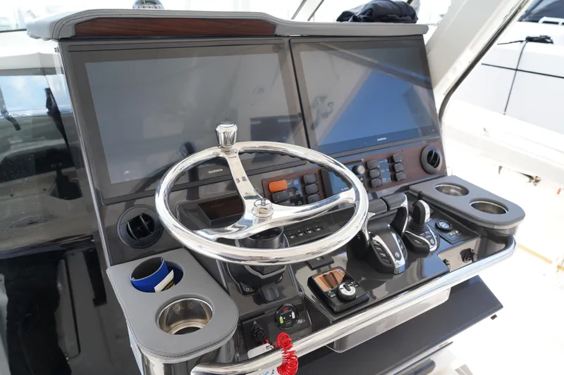  Yacht Photos Pics Helm of 2022 Pursuit 428 boat with dual screens and modern controls.
