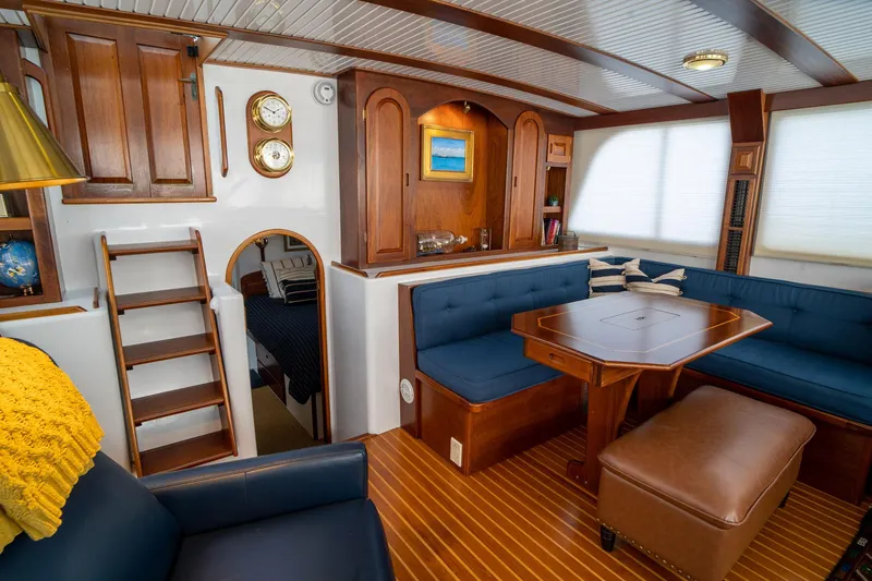 Irish Ayes Yacht Photos Pics Luxurious 1993 Atlantic Duffy 48 yacht interior with wooden accents and blue seating.