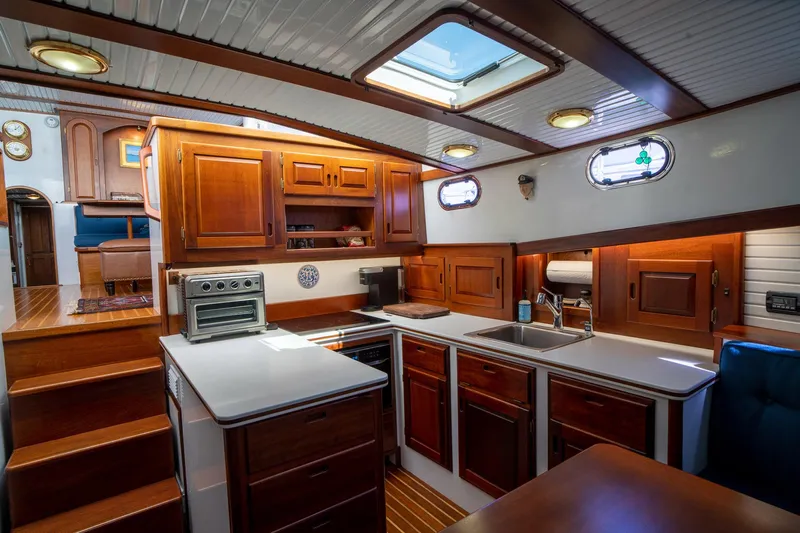 Irish Ayes Yacht Photos Pics Luxurious 1993 Atlantic Duffy 48 yacht interior with wooden cabinetry and modern kitchen amenities.