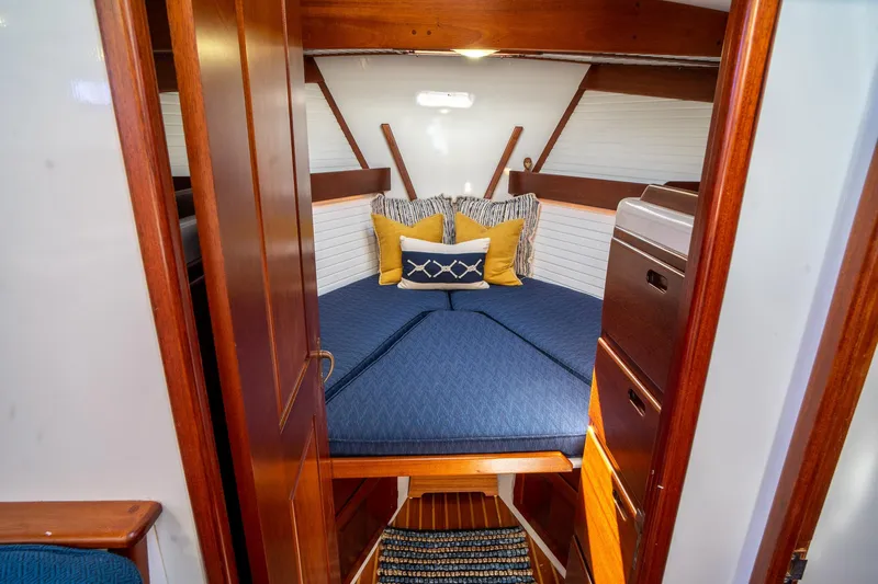 Irish Ayes Yacht Photos Pics Cozy cabin interior of 1993 Atlantic Duffy 48 with blue bedding and wooden accents.