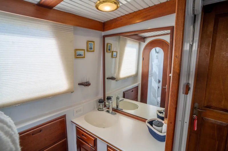 Irish Ayes Yacht Photos Pics Bathroom interior of 1993 Atlantic Duffy 48 yacht with wooden accents and mirror.