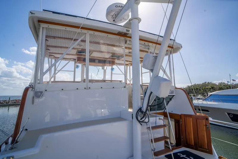 Irish Ayes Yacht Photos Pics 1993 Atlantic Duffy 48 yacht with wooden accents docked under a sunny sky.