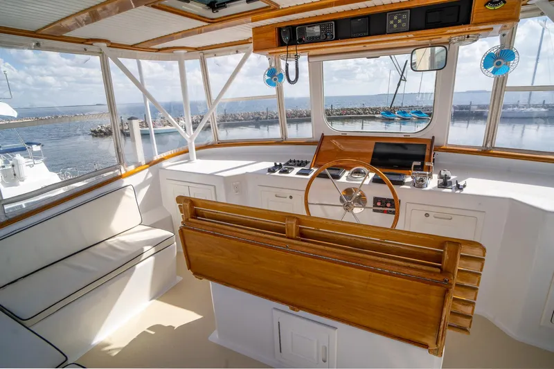 Irish Ayes Yacht Photos Pics Interior view of 1993 Atlantic Duffy 48 boat helm with wooden accents and ocean backdrop.