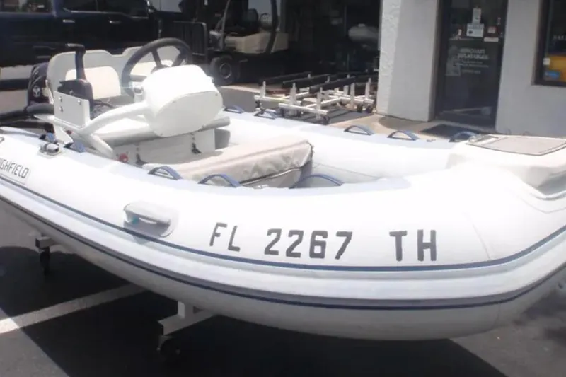 Irish Ayes Yacht Photos Pics White inflatable boat with registration FL 2267 TH, parked outside a building.